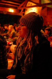 IB staff, Stephanie, prepares to recite er series of travel poems at "Open Mic Night" during Staff Week.